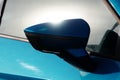 Turn signal in the car`s side mirror. Rearview mirror of a blue car, glare from the sun in the glass of the car Royalty Free Stock Photo