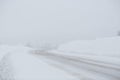 Turn on a snowy road. Snowfall and large snowdrifts Royalty Free Stock Photo