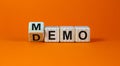 Turned cube and changed the word `demo` to `memo`. Beautiful orange background. Business and demo and memo concept. Copy space