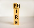 Turned a cube and changed the word `fire` to `hire`. Beautiful white background, copy space. Business concept