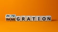 Turned a cube and changed the word `immigration` to `integration`. Beautiful orange background. Business concept. Copy space