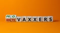 Turned a cube  changed words \'anti-vaxxers\' to \'pro-vaxxers\'. Beautiful orange background. Royalty Free Stock Photo
