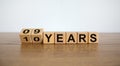 Turned cubes and changed the expression `09 years` to `10 years` or vice versa. Beautiful wooden table, white background. Busi