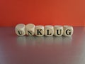 Turned dice and changes the German word unklug (stupid) to klug (smart). Beautiful grey table, red background