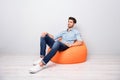 Turned full length body size photo of cheerful confident relaxing man sitting in chair contemplating thinking about his
