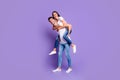 Turned full length body size photo of cute couple of two beloved people piggyback in white t-shirt smiling toothily with