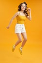 Turned full length body size photo of excited ecstatic beautiful attractive girl isolated over yellow background