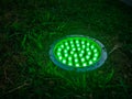 Turned on green light. Street illumination lamp in the ground. Lantern in the ground. Palm lighting Royalty Free Stock Photo