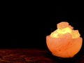 Turned on Himalayan pink salt lamp carved as a bowl.