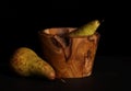 Turned wooden bowl and two pears