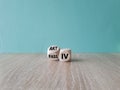 Turned a wooden cube and changes the German word passiv to aktiv. Beautiful wooden table blue background