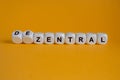 Turned wooden cube and changes the German word \'zentral\' (centralized) to \'dezentral\'