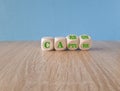 Turned wooden cubes and changed the concept green word Carbon to Capture. Beautiful wooden table blue background. Business