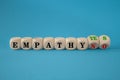 Turned wooden cubes and changes red words empathy no to empathy yes on a beautiful blue background. Psychological and empathy yes Royalty Free Stock Photo