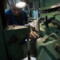 Turner middle-aged man working on a milling machine