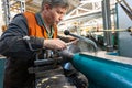 Turner worker manages the metalworking process of mechanical cutting on a lathe