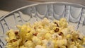 Turning around blue glass bowl full of pop corns