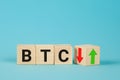 Turning a dice and changes the direction of an arrow symbolizing that the value of the crypto currency Bitcoin is going Royalty Free Stock Photo