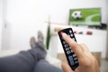 Turning off the TV. Remote control in hand. Football Royalty Free Stock Photo