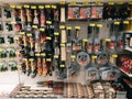 Turning paddles, large forks and grill grates hang on shelves in a supermarket