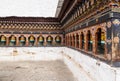 Turning prayer wheels  in Bhutan with traditional mantra whriting on them which sounds as Om mani padme hum, literally means Oh, j Royalty Free Stock Photo