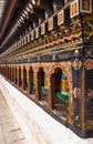 Turning prayer wheels mantra in Bhutan with traditional writing mantra which sounds as `Om mani padme hum`, literally means Oh, je Royalty Free Stock Photo