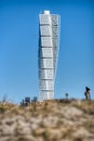 Turning Torso with a blurred person. Skyscraper with a contemporary facade bears a modern lifestyle and futuristic architecture