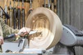 Turning wooden bowls on a lathe. The close up view of spinning the lathe machine