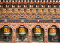 Turning wooden prayer wheels mantra in Bhutan with traditional writing mantra which sounds as Om mani padme hum, literally means `