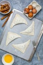 Turnovers with apple filling on a baking sheet