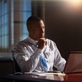 he turns to his intuition when making tough decisions. a young man contemplating while using his laptop. Royalty Free Stock Photo