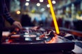 Turntable, hand of dj on the vinyl record at night club. blured background Royalty Free Stock Photo