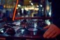 Turntable, hand of dj on the vinyl record at night club. blured background Royalty Free Stock Photo