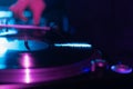 Turntable playing analog vinyl record with music on hip hop party in dark night club Royalty Free Stock Photo