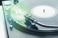 Turntable playing music with audio notes glowing