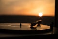 Turntable vinyl record player on the background of a sunset over the mountains. Sound technology for DJ to mix & play music. Black Royalty Free Stock Photo