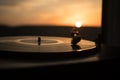 Turntable vinyl record player on the background of a sunset over the mountains. Sound technology for DJ to mix & play music. Black Royalty Free Stock Photo