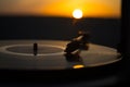 Turntable vinyl record player on the background of a sunset over the mountains. Sound technology for DJ to mix & play music. Black Royalty Free Stock Photo