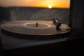 Turntable vinyl record player on the background of a sunset over the mountains. Sound technology for DJ to mix & play music. Black Royalty Free Stock Photo