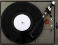 Turntable vinyl record player on the background white wooden boards. Sound technology for DJ to mix & play music. Needle on a Royalty Free Stock Photo