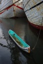 A turquise lonely canoe is parked in Sunda Kelapa Sea port Jakarta Royalty Free Stock Photo