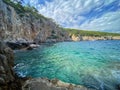 Turquoise Adriatic Sea and tropical cliffs under the bright sky in Dubrovnik, Croatia Royalty Free Stock Photo