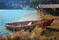 turquoise alpine lake lautersee with moored rowing boat an boathouses Royalty Free Stock Photo