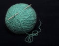 Turquoise ball of acrylic-wool yarn and crochet hook