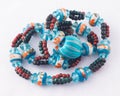 Turquoise bead necklace in a crumpled pile isolated on white