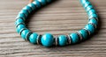 AI--generated Turquoise Bead Necklace With Silver Spacers Resting On Rustic Wooden Surface Royalty Free Stock Photo