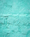 Turquoise blue brick wall detail texture background. Old, painted, weathered and cracked stone bricks with concrete and stucco Royalty Free Stock Photo