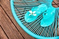 Turquoise blue garden chair and flip flops Royalty Free Stock Photo