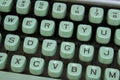 A turquoise blue keys of a vintage typewriter close-up with the English alphabet