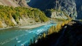 Turquoise blue water of Ghizer river flowing through forest in Gahkuch, Gilgit Baltistan, Pakistan.